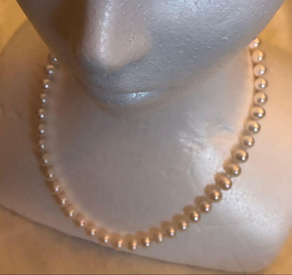 Akoya pearl round necklace with 7-7.5mm white pearls on a 44cm chain laid flat
