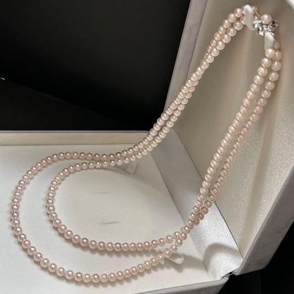 Long Akoya pearl necklace with 6.5mm pink pearls measuring 124cm with sterling silver details