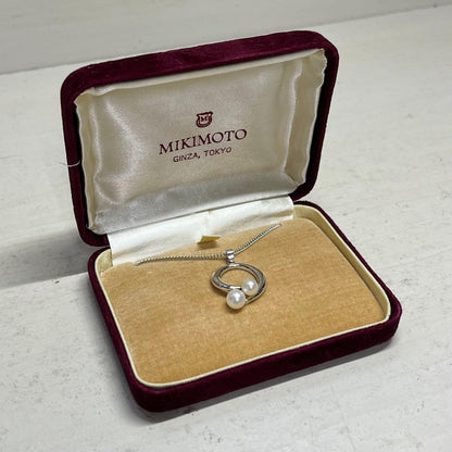 MIKIMOTO pearl necklace in silver color with 24 cm length displayed on a white background