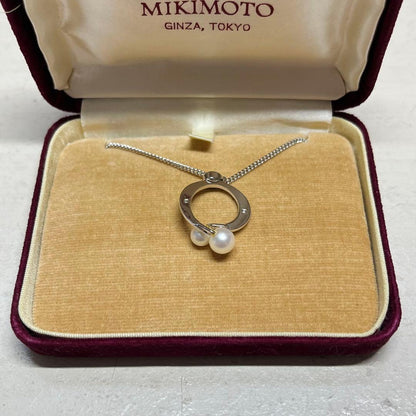 MIKIMOTO pearl necklace in silver color with 24 cm length displayed on a white background