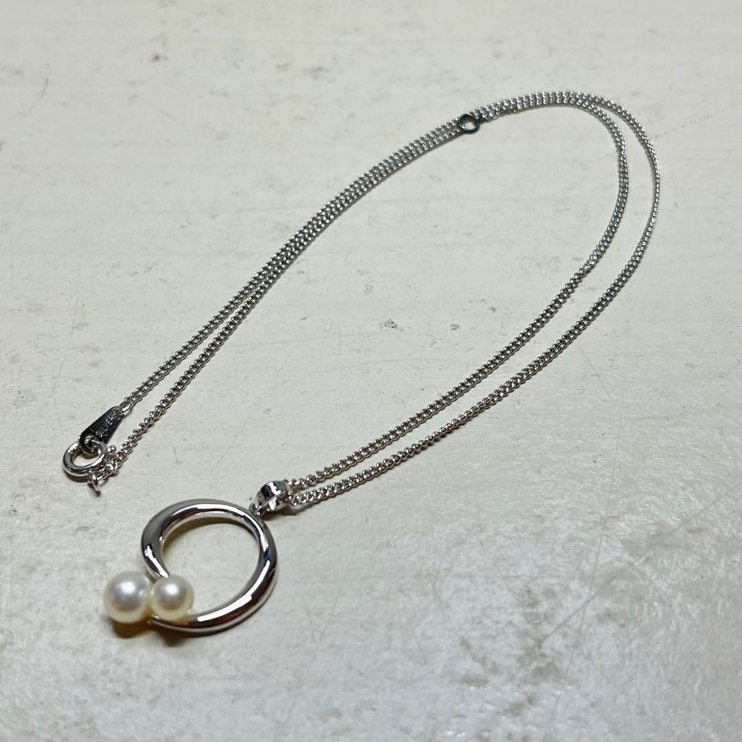 MIKIMOTO pearl necklace in silver color with 24 cm length displayed on a white background