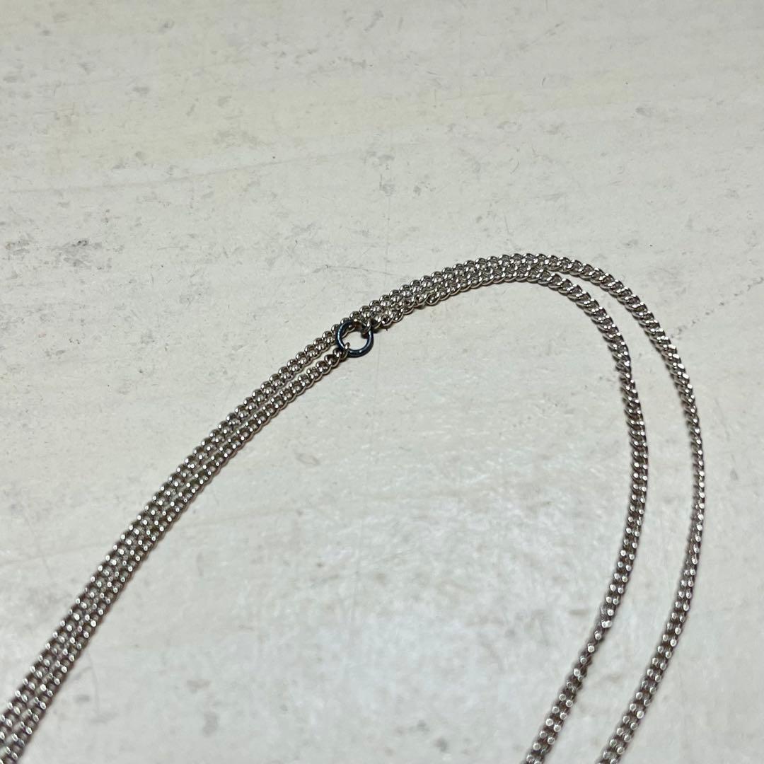 MIKIMOTO pearl necklace in silver color with 24 cm length displayed on a white background