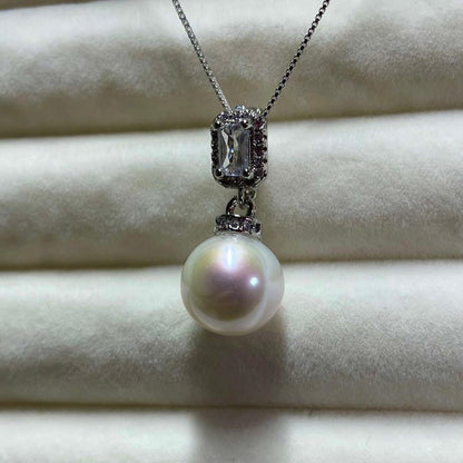 Akoya pearl necklace with 10mm large white pearls and silver pendant featuring baguette and melee stones