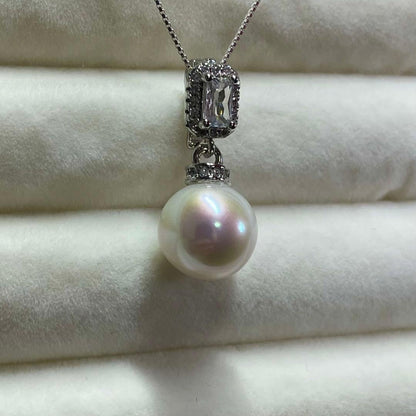 Akoya pearl necklace with 10mm large white pearls and silver pendant featuring baguette and melee stones