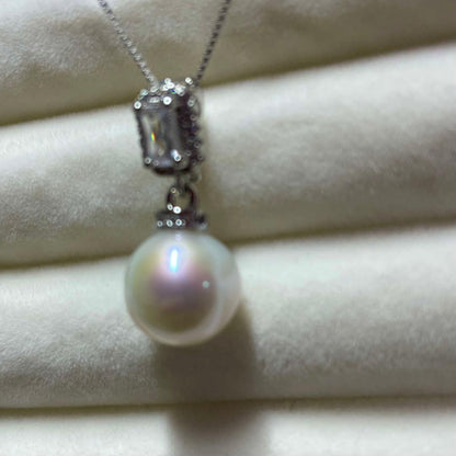 Akoya pearl necklace with 10mm large white pearls and silver pendant featuring baguette and melee stones