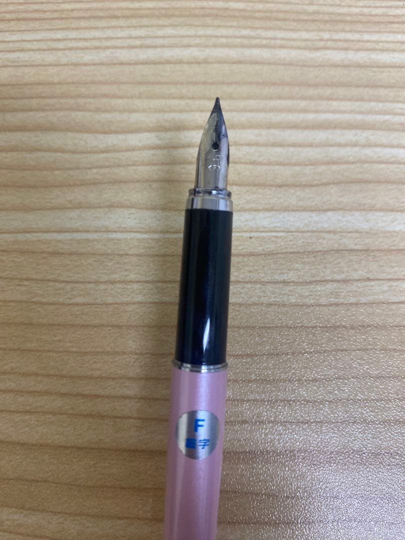 Pilot Cavalier Fountain Pen in pink with fine (F) tip shown uncapped on white background