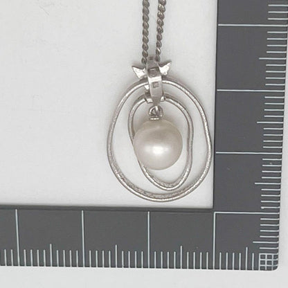 Mikimoto necklace with one cultured white pearl bead on a silver chain with Mikimoto engraved clasp