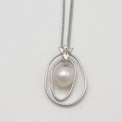 Mikimoto necklace with one cultured white pearl bead on a silver chain with Mikimoto engraved clasp