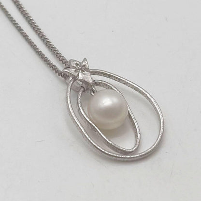 Mikimoto necklace with one cultured white pearl bead on a silver chain with Mikimoto engraved clasp