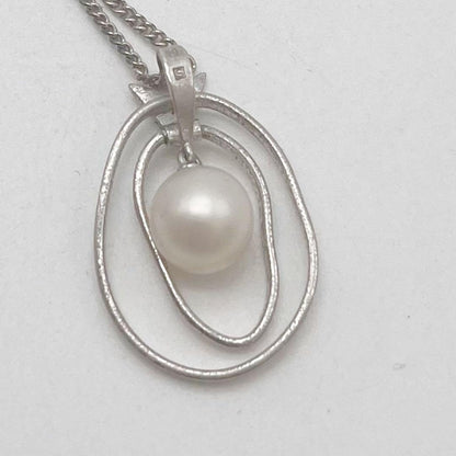 Mikimoto necklace with one cultured white pearl bead on a silver chain with Mikimoto engraved clasp