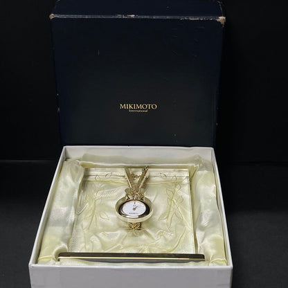 Mikimoto pendant watch with 4mm pearl and 2.5cm clock on a 70cm chain with clock stand