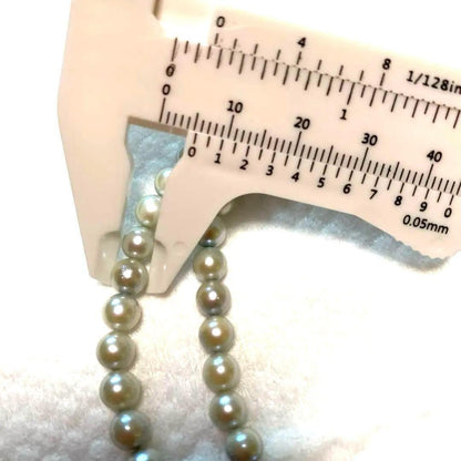Akoya Pearl Necklace Aurora with 4.0-4.5mm white pink pearls and silver clasp on white background