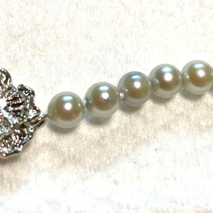 Akoya Pearl Necklace Aurora with 4.0-4.5mm white pink pearls and silver clasp on white background