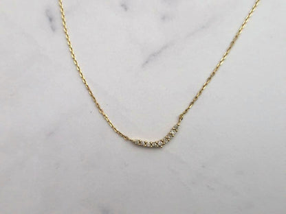 Agete K18 gold necklace featuring a 0.04 carat diamond with a stylish curve motif design