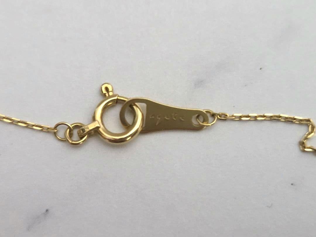 Agete K18 gold necklace featuring a 0.04 carat diamond with a stylish curve motif design