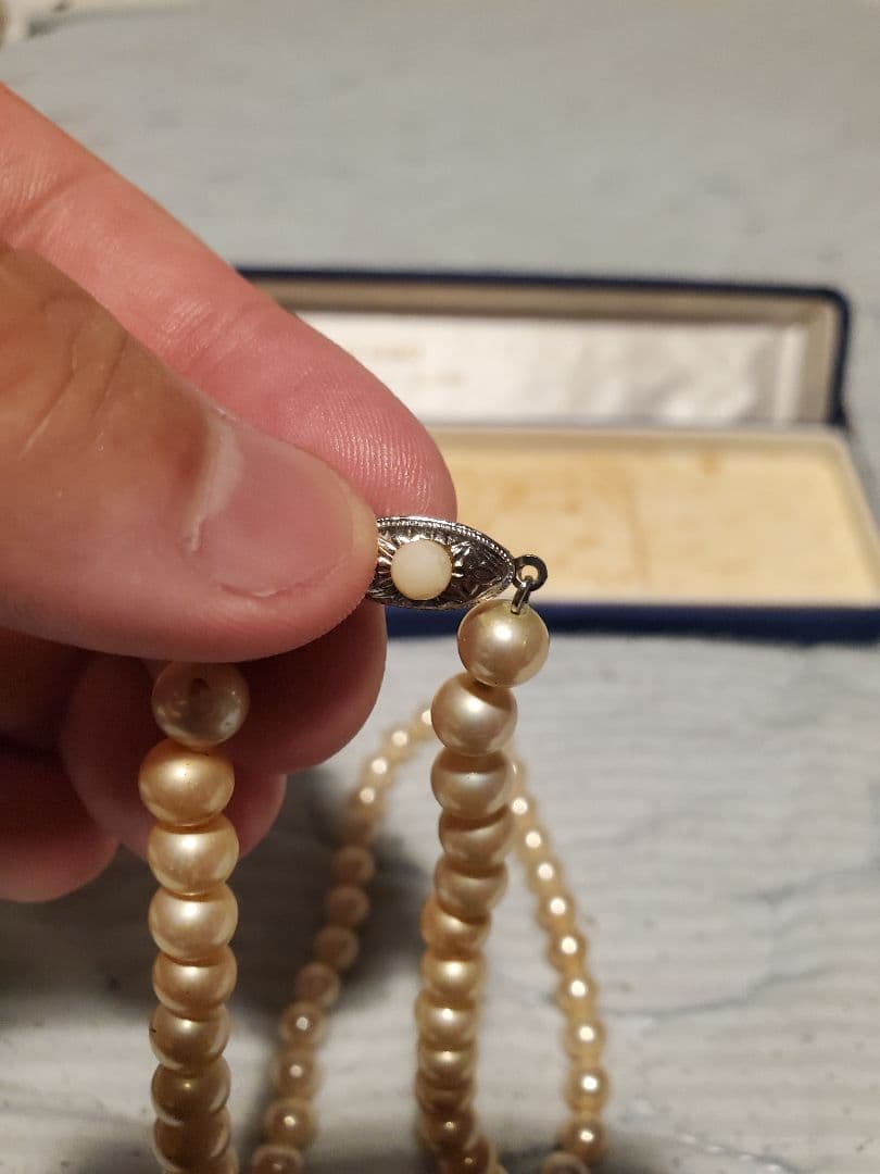 MIKIMOTO pearl necklace featuring round pearls and a pearl decorated clasp