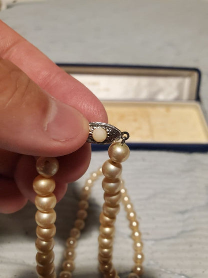 MIKIMOTO pearl necklace featuring round pearls and a pearl decorated clasp