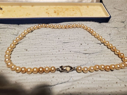 MIKIMOTO pearl necklace featuring round pearls and a pearl decorated clasp