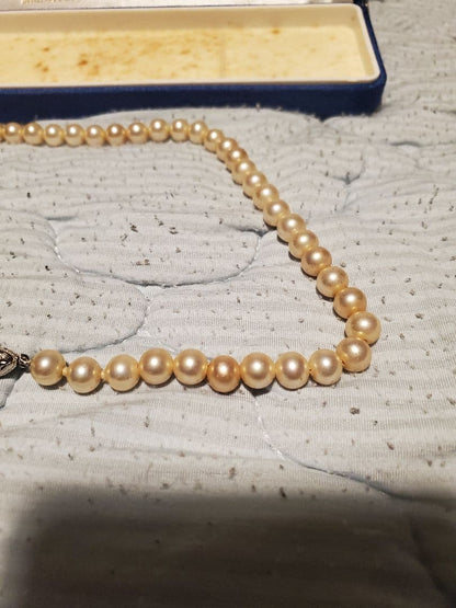 MIKIMOTO pearl necklace featuring round pearls and a pearl decorated clasp