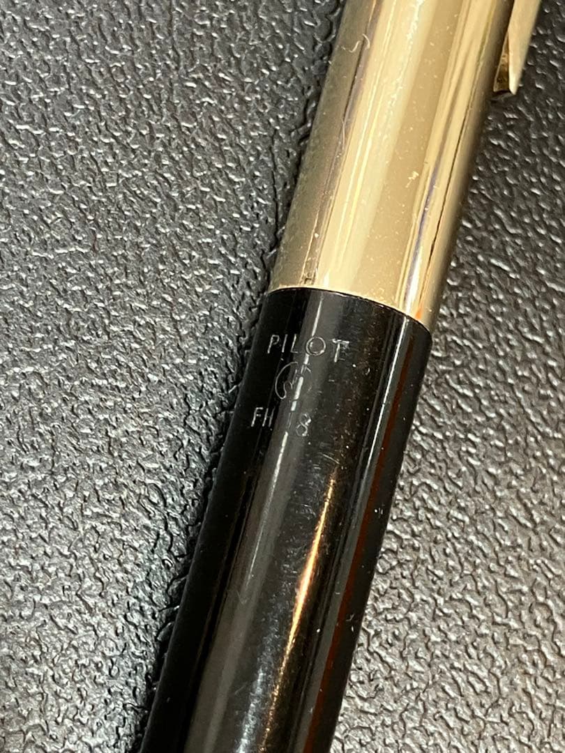 Pilot mechanical pencil in black and gold metal showing barrel and tip