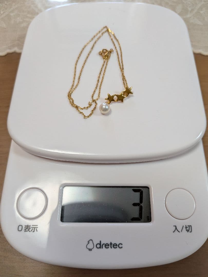Mikimoto 18K gold necklace with star-shaped design and pearl pendant weighing approximately 3 grams
