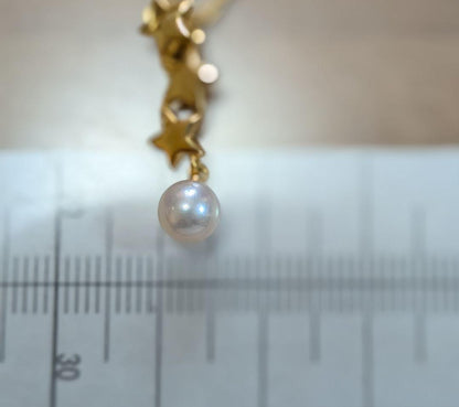 Mikimoto 18K gold necklace with star-shaped design and pearl pendant weighing approximately 3 grams