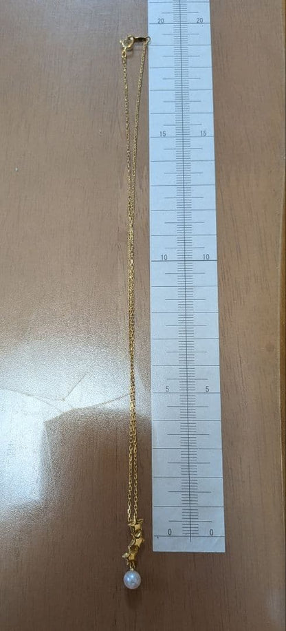 Mikimoto 18K gold necklace with star-shaped design and pearl pendant weighing approximately 3 grams