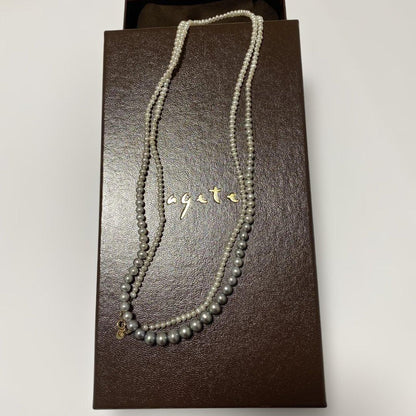 Agete Gradient Long Pearl Necklace measuring 100 cm with varying pearl sizes on a white background