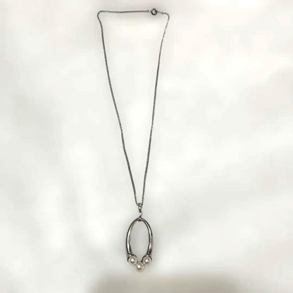 Mikimoto baby pearl necklace with 5mm white pearl on silver chain featuring brand logo and silver engraving