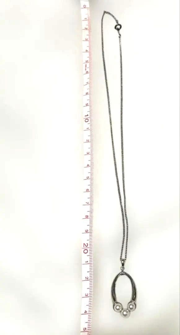 Mikimoto baby pearl necklace with 5mm white pearl on silver chain featuring brand logo and silver engraving