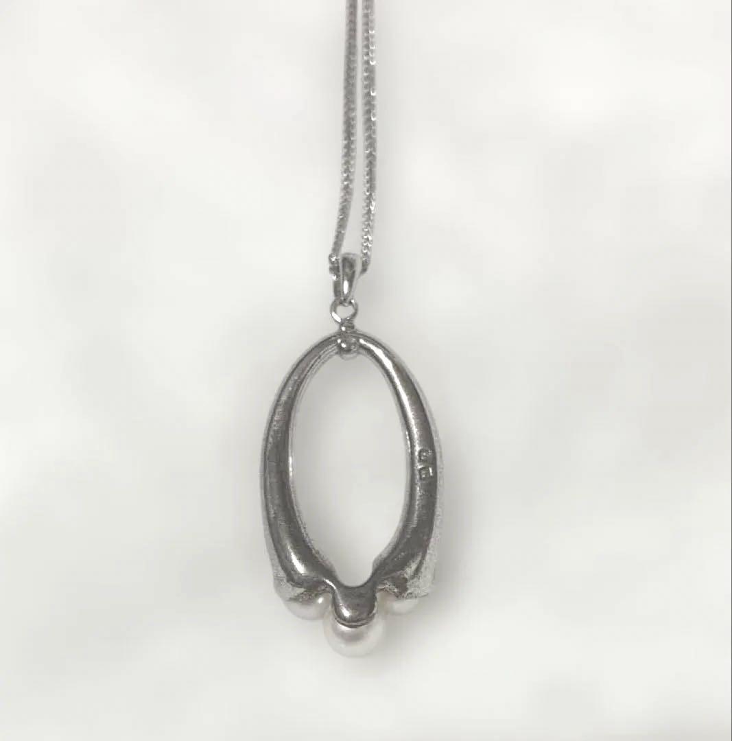 Mikimoto baby pearl necklace with 5mm white pearl on silver chain featuring brand logo and silver engraving