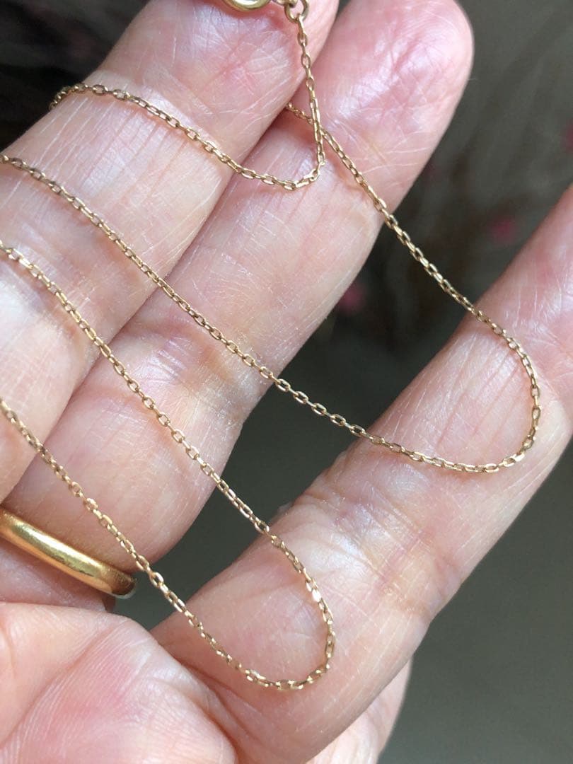 Agete K10 yellow gold necklace chain 40cm with attached earring charm on white background