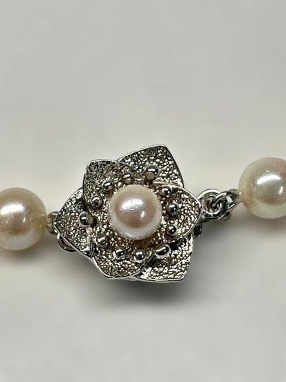 Akoya pearl necklace with 6.0mm pearls and silver clasp, displayed with stamped case