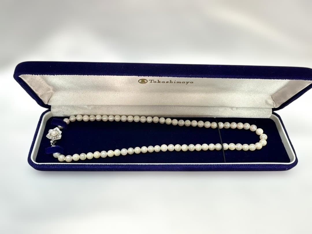 Akoya pearl necklace with 6.0mm pearls and silver clasp, displayed with stamped case
