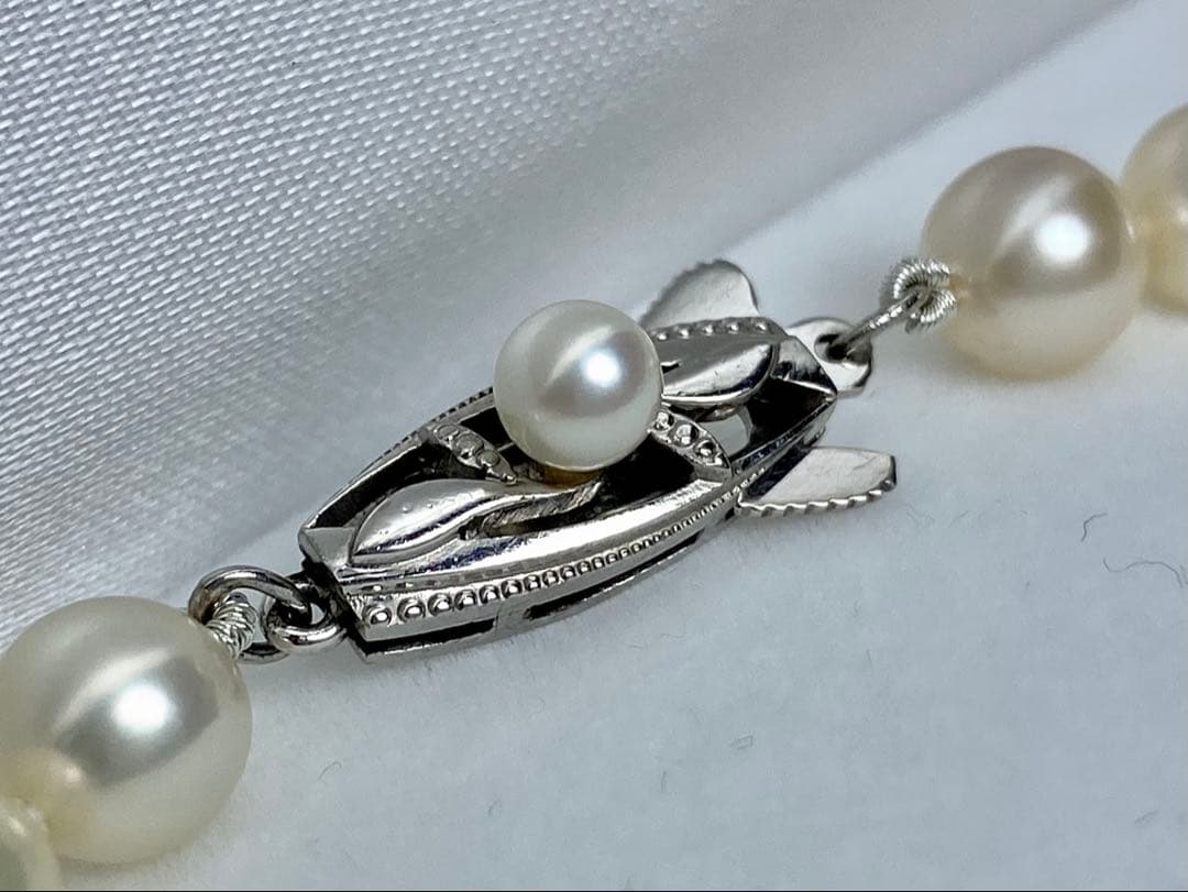 MIKIMOTO K14 Akoya pearl necklace with 6.5-7mm pearls, M charm, and K14WG mark on white background