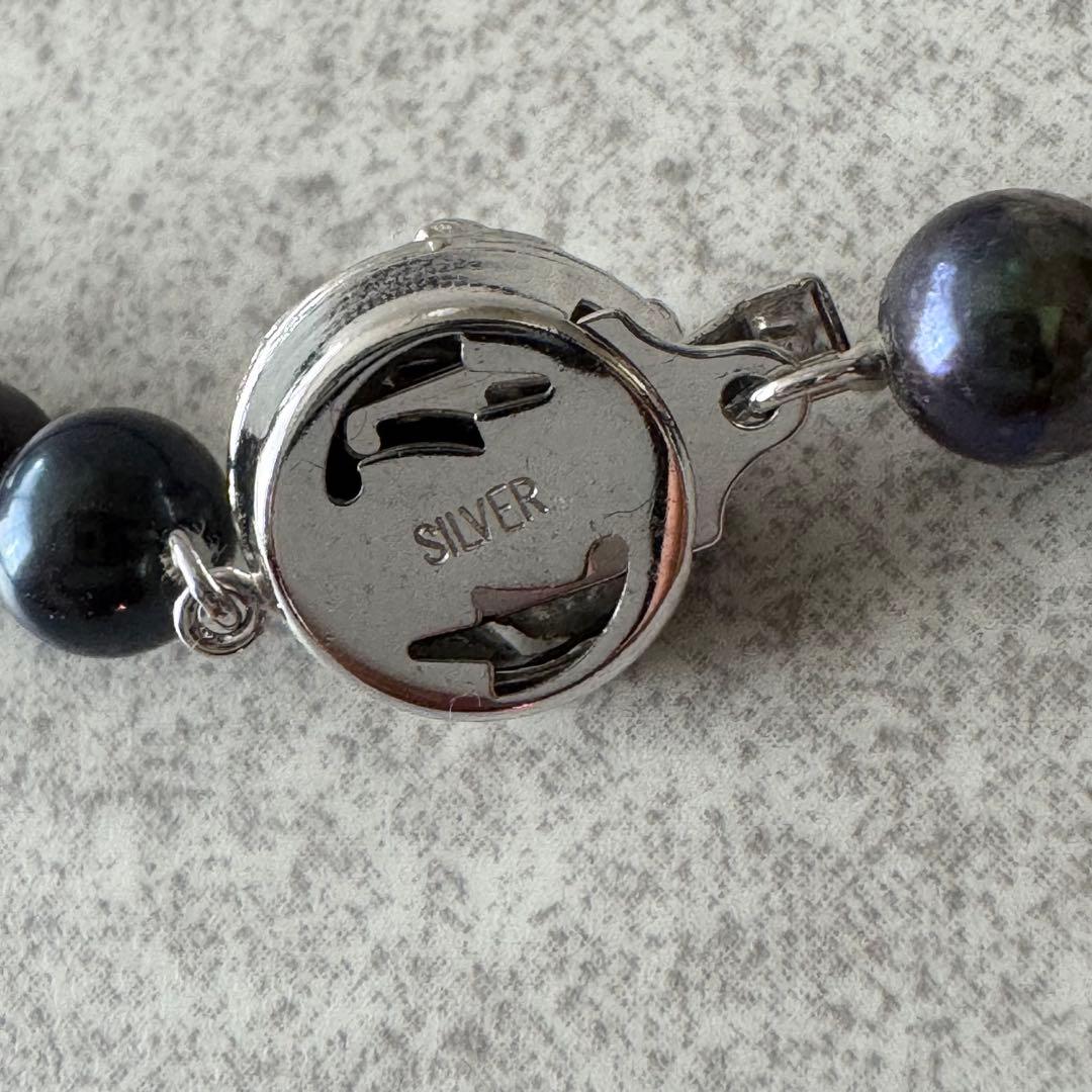 Honma Pearl genuine black Akoya pearl necklace with 7.4mm pearls and silver clasp on a white background