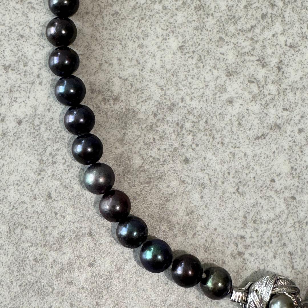 Honma Pearl genuine black Akoya pearl necklace with 7.4mm pearls and silver clasp on a white background