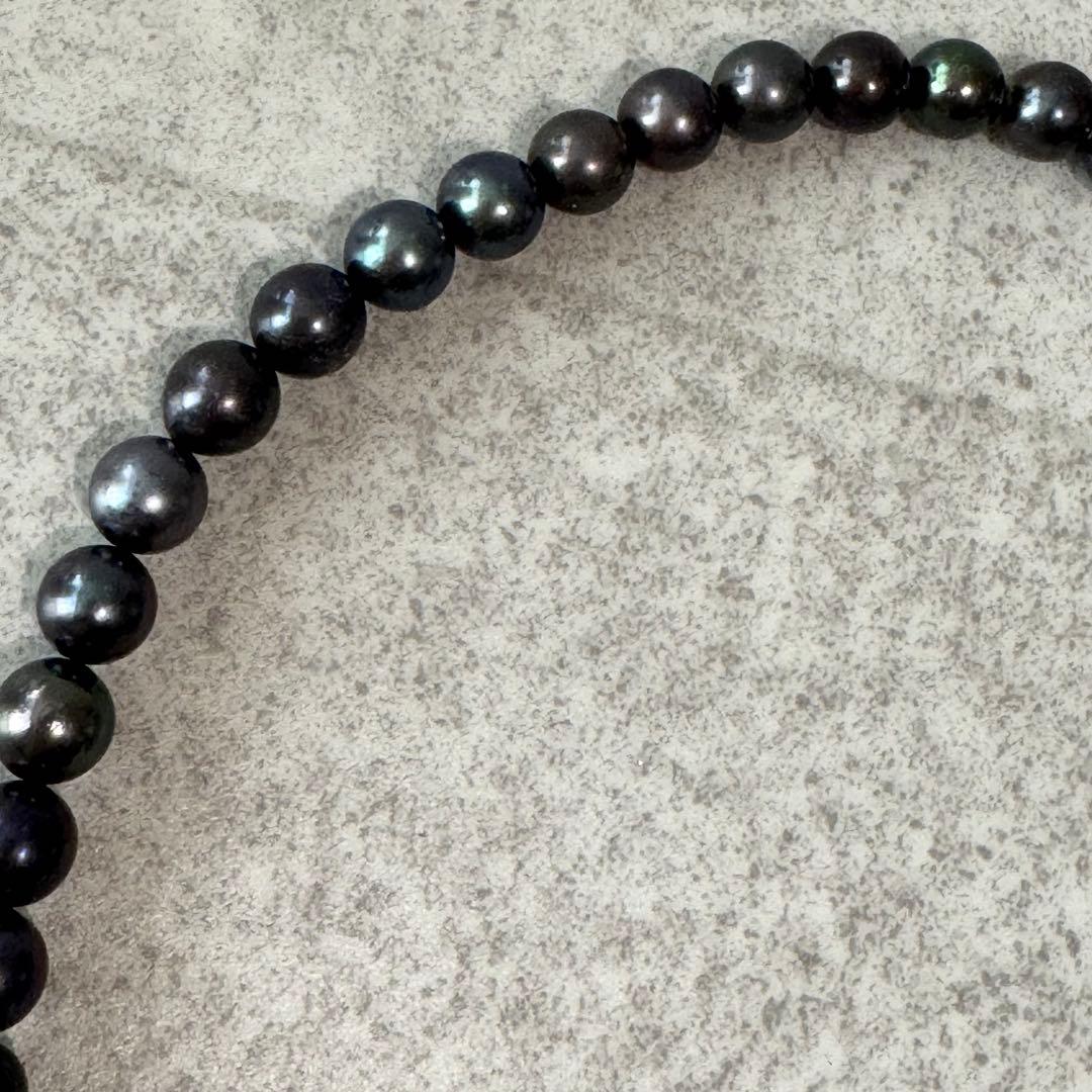 Honma Pearl genuine black Akoya pearl necklace with 7.4mm pearls and silver clasp on a white background