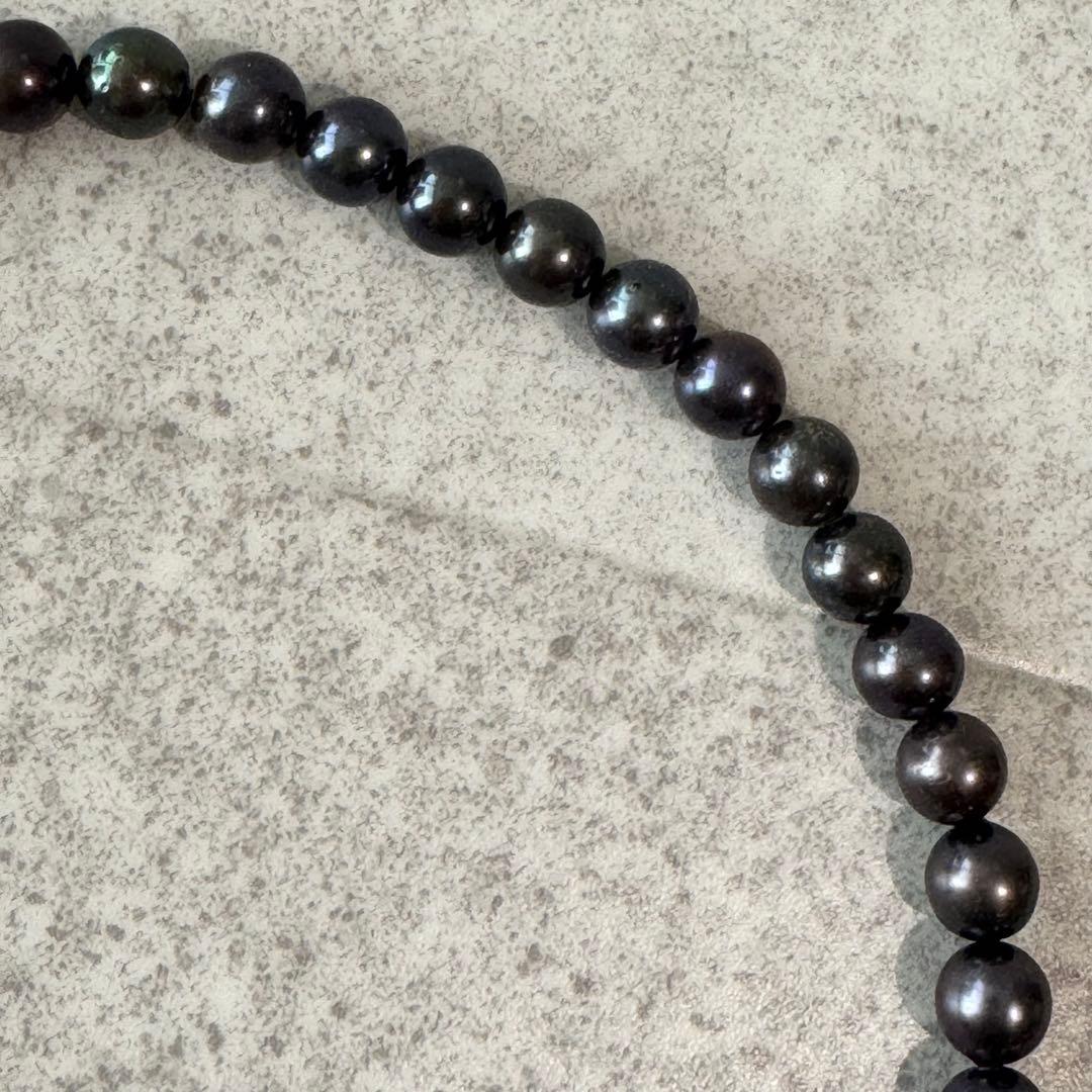Honma Pearl genuine black Akoya pearl necklace with 7.4mm pearls and silver clasp on a white background