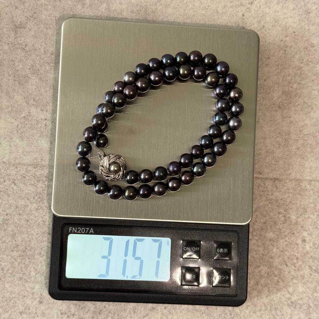 Honma Pearl genuine black Akoya pearl necklace with 7.4mm pearls and silver clasp on a white background