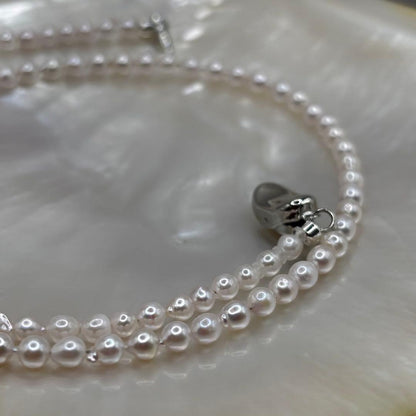 Akoya pearl baby pearl baroque necklace with white pink pearls and 925 clasp on white background
