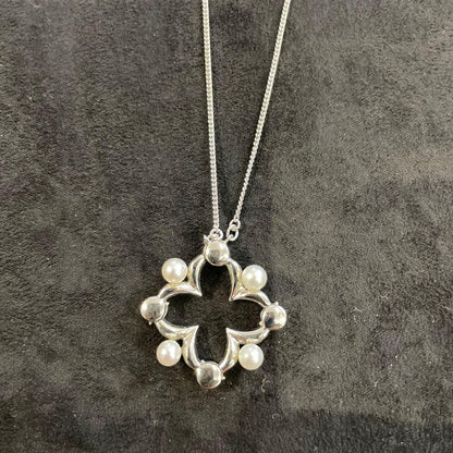Silver pearl necklace with 200 mm length and delicate design displayed on white background