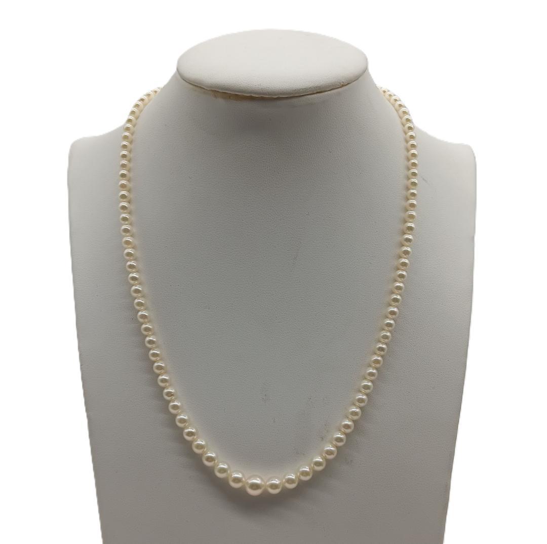 Mikimoto Akoya pearl gradient necklace with pearls ranging 3 to 7 mm displayed with velour case