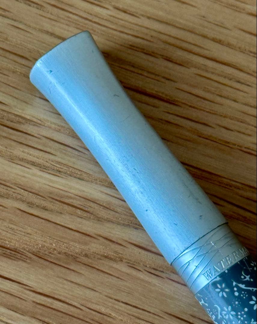Waterman Odoce Shine Pearl silver ballpoint pen with small scratches on the cap, shown uncapped on a white background