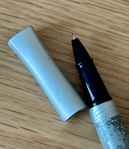 Waterman Odoce Shine Pearl silver ballpoint pen with small scratches on the cap, shown uncapped on a white background