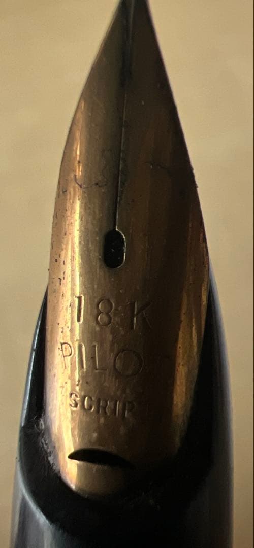 Close-up of PILOT 18k fountain pen showing gold nib and sleek design