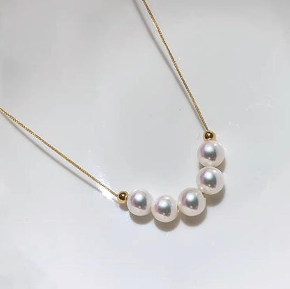K18YG yellow gold necklace with 6-7mm Akoya pearls and Y-shaped 2Way Chopin chain on white background