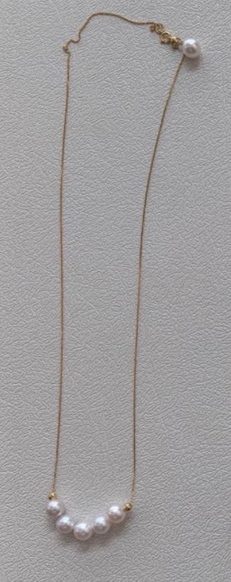 K18YG yellow gold necklace with 6-7mm Akoya pearls and Y-shaped 2Way Chopin chain on white background