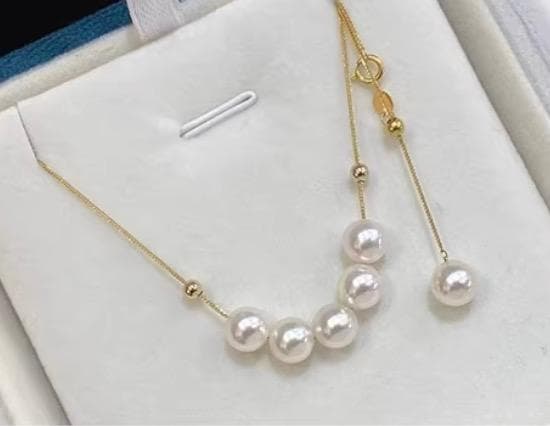 K18YG yellow gold necklace with 6-7mm Akoya pearls and Y-shaped 2Way Chopin chain on white background