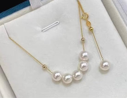 K18YG yellow gold necklace with 6-7mm Akoya pearls and Y-shaped 2Way Chopin chain on white background